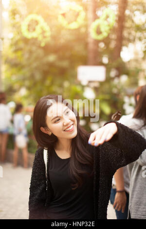 Woman enjoying Butterfly perched on her hand at the park Stock Photo