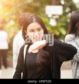 Woman enjoying Butterfly perched on her hand at the park Stock Photo