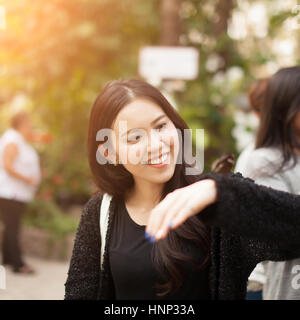 Woman enjoying Butterfly perched on her hand at the park Stock Photo