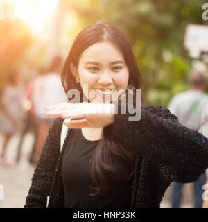 Woman enjoying Butterfly perched on her hand at the park Stock Photo