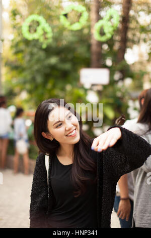 Woman enjoying Butterfly perched on her hand at the park Stock Photo