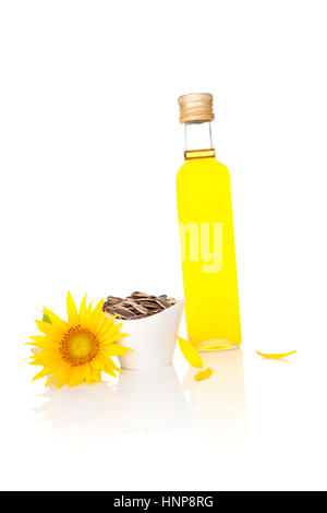 Sunflower oil in glass bottle and fresh sun-flower isolated on white background. Stock Photo