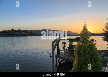 Ula lake during sunset with pine tree and and lamp Stock Photo