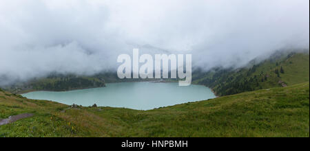 thick white mist over the Big Almaty Lake, large natural reservoir of fresh water Stock Photo