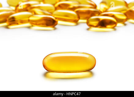 Close up one capsule Omega 3 and many other of capsules isolated on white background. High resolution product. Health care concept Stock Photo