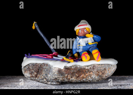 UMEA, SWEDEN ON SEPTEMBER 23, 2013. Handmade figure of modeling clay on a stone. Black background. Illustrative Editorial. Stock Photo
