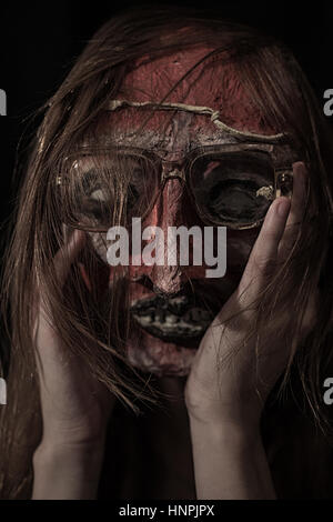 Horrible theatrical mask dressed In Glasses closeup Stock Photo