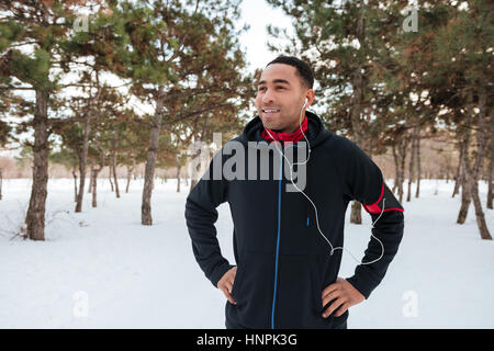 Young afro american man taking a break while doing winter fitness session Stock Photo