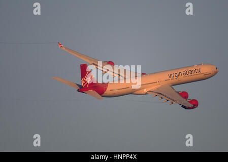 Virgin Atlantic Airways Airbus A340-642 G-VBUG 'Lady Bird' taking off from London Heathrow Airport in blue sky Stock Photo