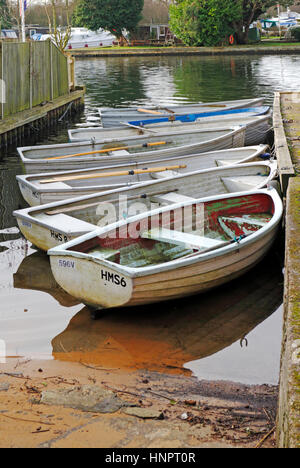 Seven small boats moored on a river Stock Photo - Alamy