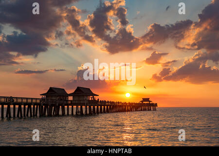 Setting sun over the Naples Pier and Gulf of Mexico, Naples, Florida, USA Stock Photo