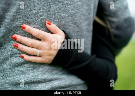 A couple recently engaged show their love for each other near seven sisters, East Sussex, UK. Stock Photo