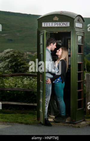 A couple recently engaged show their love for each other near seven sisters, East Sussex, UK. Stock Photo