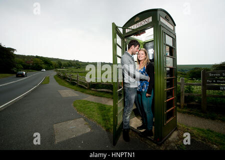 A couple recently engaged show their love for each other near seven sisters, East Sussex, UK. Stock Photo