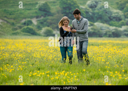 A couple recently engaged show their love for each other near seven sisters, East Sussex, UK. Stock Photo