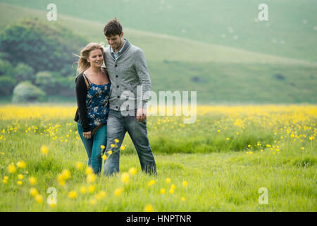 A couple recently engaged show their love for each other near seven sisters, East Sussex, UK. Stock Photo