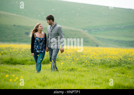 A couple recently engaged show their love for each other near seven sisters, East Sussex, UK. Stock Photo