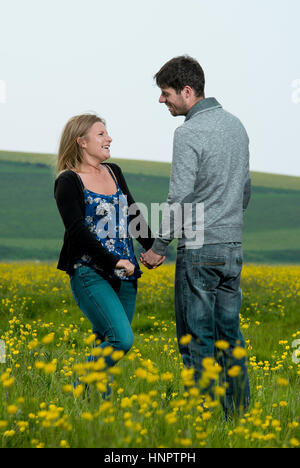 A couple recently engaged show their love for each other near seven sisters, East Sussex, UK. Stock Photo