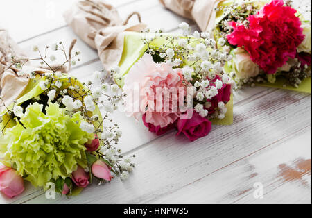 Mini flower bouquet with roses and carnation Stock Photo - Alamy