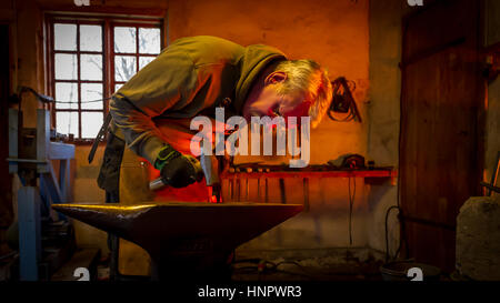 The Torresta Blacksmith strike while the iron is hot in Uppland, Sweden Stock Photo