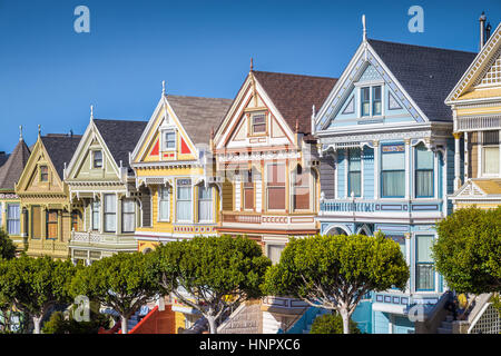 Classic postcard view of famous Painted Ladies, a row of colorful Victorian houses located at Alamo Square, on a beautiful sunny day, San Francisco Stock Photo