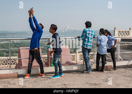Indian teenagers take selfies with the Taj Mahal, Agra Fort, India Stock Photo
