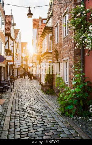 Vertical view of an old town in Europe in beautiful golden evening light at sunset in summer with pastel toned retro vintage Instagram filter effect Stock Photo