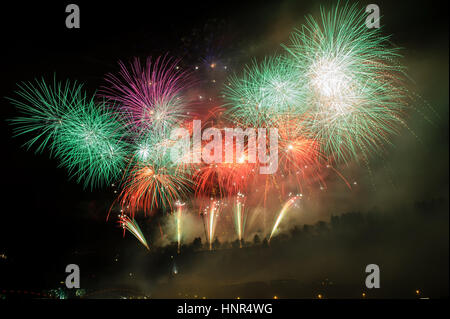 Great fireworks celebration of new year on dark night sky. Full of colors and sparkling stars. Stock Photo