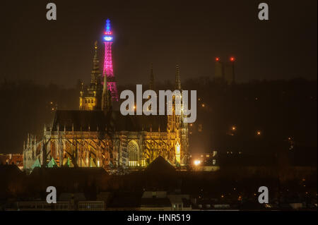 The Petrin Lookout Tower in Prague lit up with the Tricolor with Prague castle in front. Beautiful night city scenery Stock Photo
