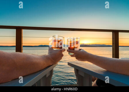 Sunset with drinks on the deck couple Stock Photo