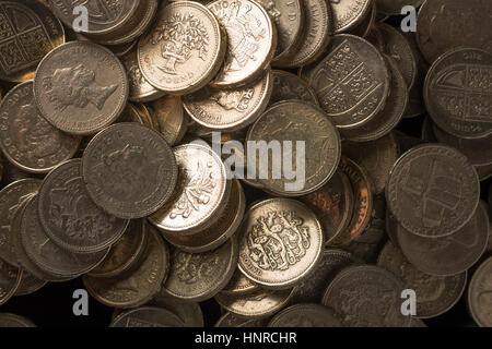 Stacks of pound coins arranged in piles. Stock Photo