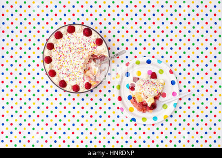 Trifle on a colourful polka dot plate and table cloth Stock Photo