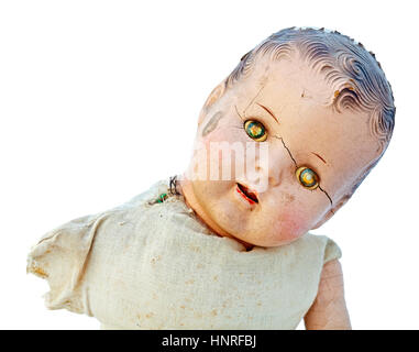 Dilapidated child's doll with scary zombie-likw expression. Stock Photo