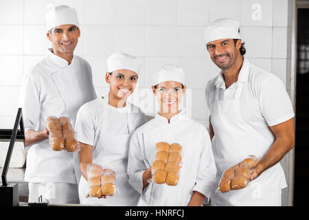 Baker's Showing Packed Breads In Bakery Stock Photo
