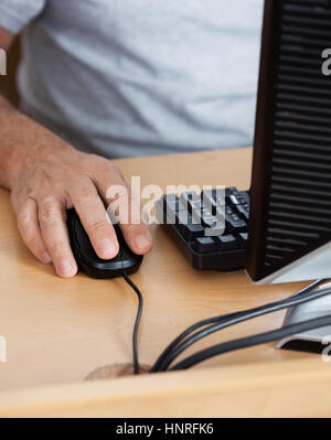Midsection Of Senior Man Using Computer In Classroom Stock Photo
