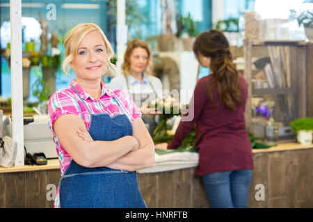 Portrait Of Confident Female Florist In Shop Stock Photo
