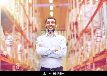 wholesale, logistic, business, export and people concept - happy man at warehouse Stock Photo