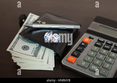 Wallet with dollars, pen and calculator on wooden table. Financial success sign Stock Photo