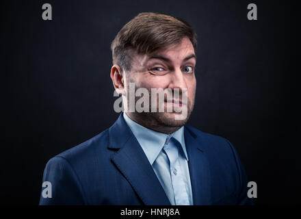 Brutal man in suit on black background. Studio photo shoot Stock Photo