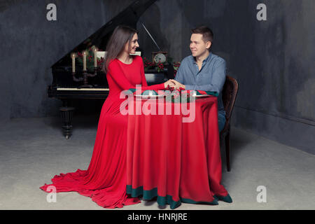 Man making marriage proposal sweetheart in vintage restaurant. Retro piano on background Stock Photo