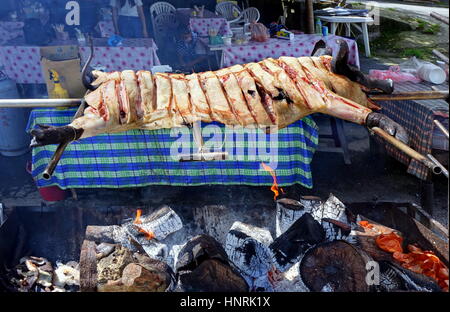 KAOHSIUNG, TAIWAN -- JULY 24, 2016: A traditional market in the aboriginal mountain village of Baoshan offers black pig roasted over an open fire. Stock Photo