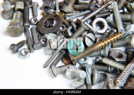 A lot of screws and nuts on a white background Stock Photo