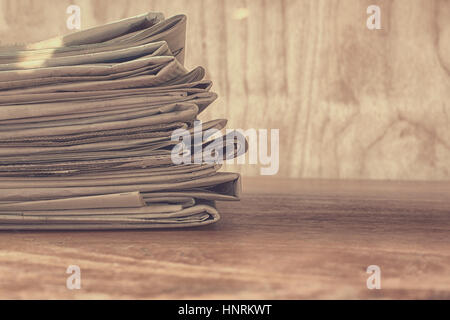 Stack of newspapers on a table Stock Photo