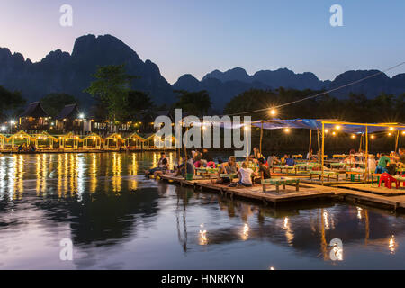 Vang Vieng, Laos - January 19, 2017: Restaurant on the riverfront during sunset in Vang Vieng, Laos Stock Photo