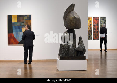 Cologne, Germany. 16th Feb, 2017. L-R: The painting 'Composition' (1930), the bronze sculpture 'Ascent' (1929/1960) and the painting 'Homage to the Coloured Peoples' (1938) by Otto Freundlich on display as part of the Ludwig Museum's 'Otto Freundlich: Cosmic Communism' show in Cologne, Germany, 16 February 2017. Photo: Henning Kaiser/dpa/Alamy Live News Stock Photo