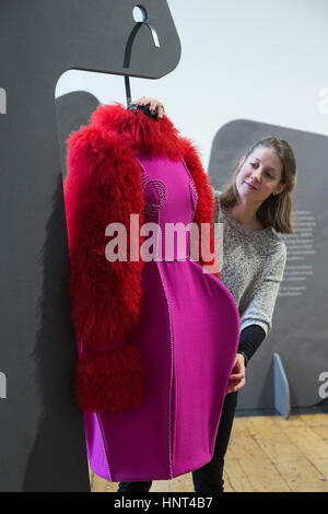 London, UK. 16th Feb, 2017. Exhibition assistant Monique Ricketts looks at a purple dress by David Ferreira from Portugal. The British Council, British Fashion Council (BFC) and Mercedes-Benz are collectively presenting work by emerging fashion designers from 26 countries for the 6th annual edition of the International Fashion Showcase (IFS) 2017 at Somerset House. The showcase is on display during London Fashion Week from 17 to 21 February 2017. Credit: Bettina Strenske/Alamy Live News Stock Photo