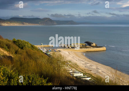 Lyme Regis, Dorset, UK. 16th Feb, 2017. UK Weather. An Easterly view across The Cobb Harbour at Lyme Regis in Dorset, illuminated by late afternoon sunshine on a day of above average temperatures. Credit: Graham Hunt/Alamy Live News Stock Photo