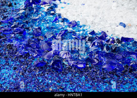 Shards of glass bottles green, scattered on the white surface Stock Photo
