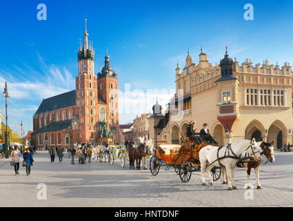 Cracow - Carriage waiting for tourists, St Mary's Church in the background, Poland UNESCO Stock Photo