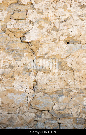 old cracked plastered stone wall background texture Stock Photo